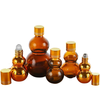 Konfigurowalne, wysokiej jakości butelki roll-on na olejki zapachowe z brązowego szkła o pojemności 10 ml/50 ml/100 ml ze złotym lustrzanym wykończeniem, podwójnymi złotymi zakrętkami i pogrubioną podstawą